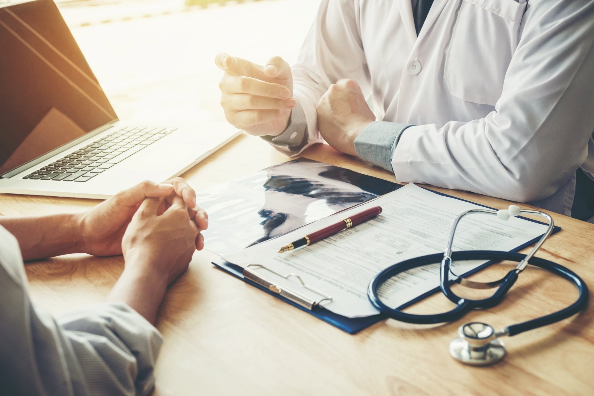 Doctor discussing healthcare data organized by Hart and its cost considerations with a patient