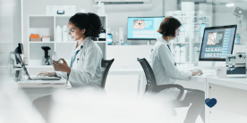 Physicians reviewing patient data and working together