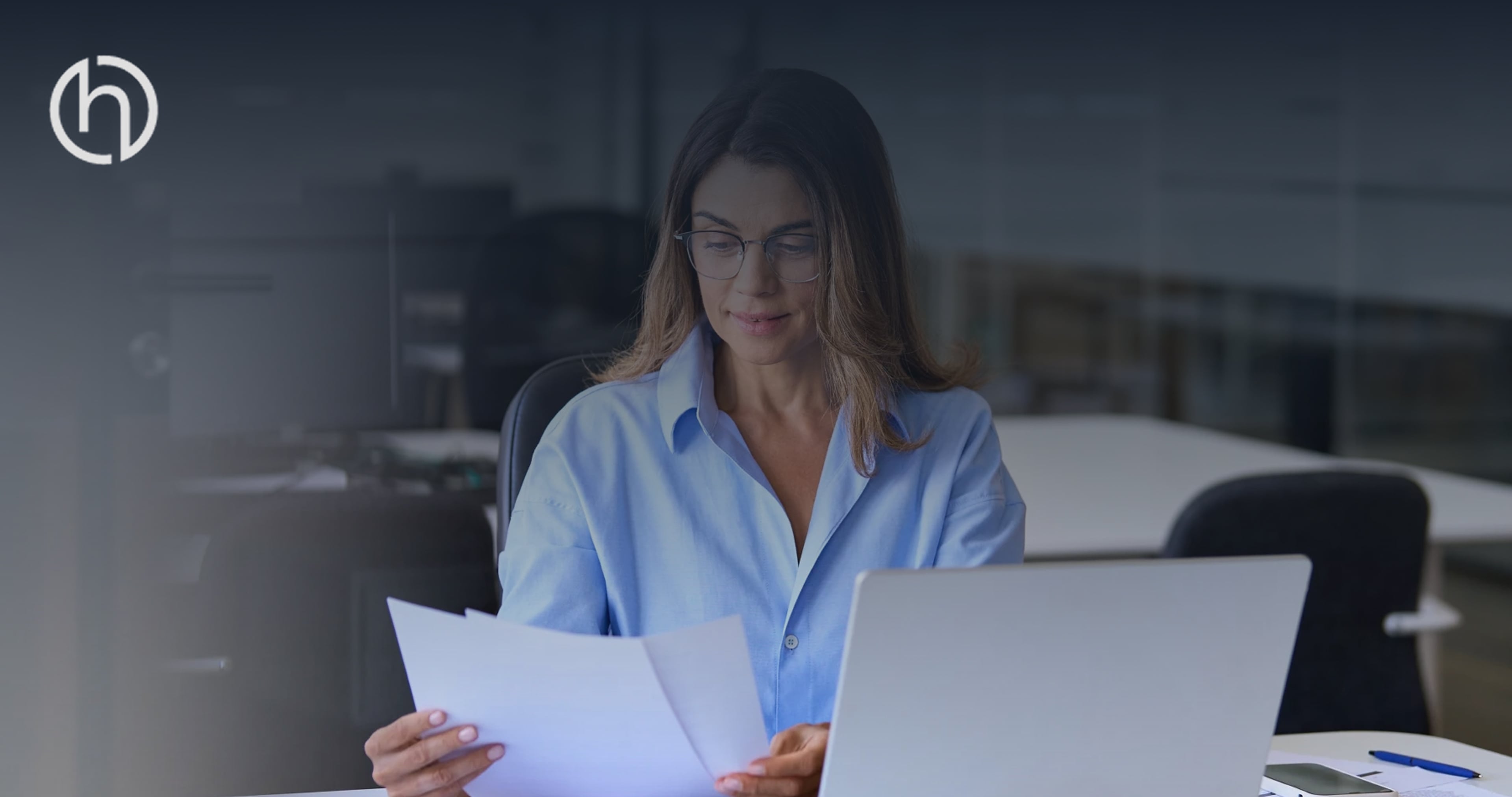 woman looking at paper instead of computer
