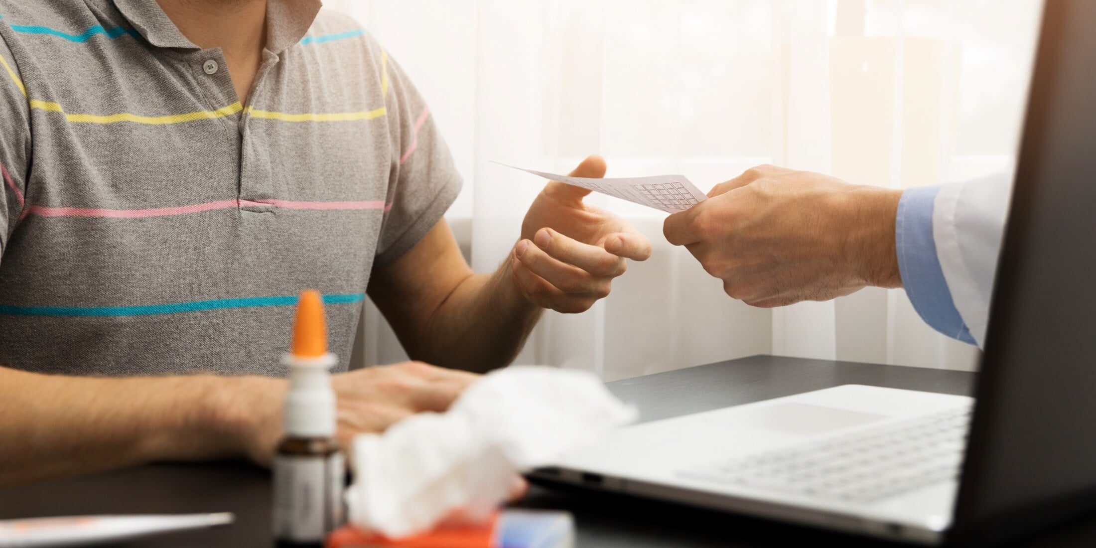 A doctor giving a prescription to a patient after consultation.